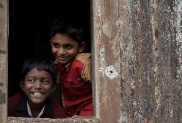 Children peeking from a door